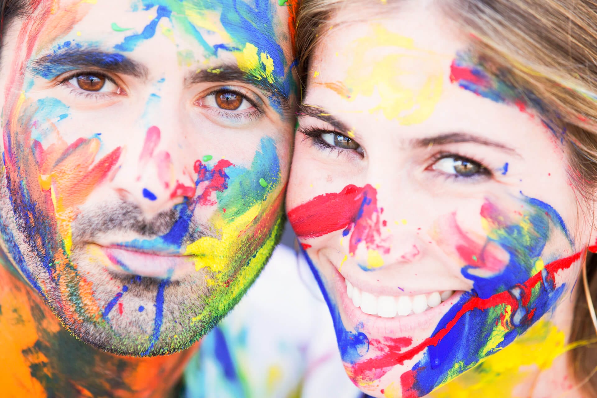 Creative NYC engagement session with the couple sporting face paint as an alternative to props, photographed by a award-winning NYC wedding photographer, Kiss Me in New York.