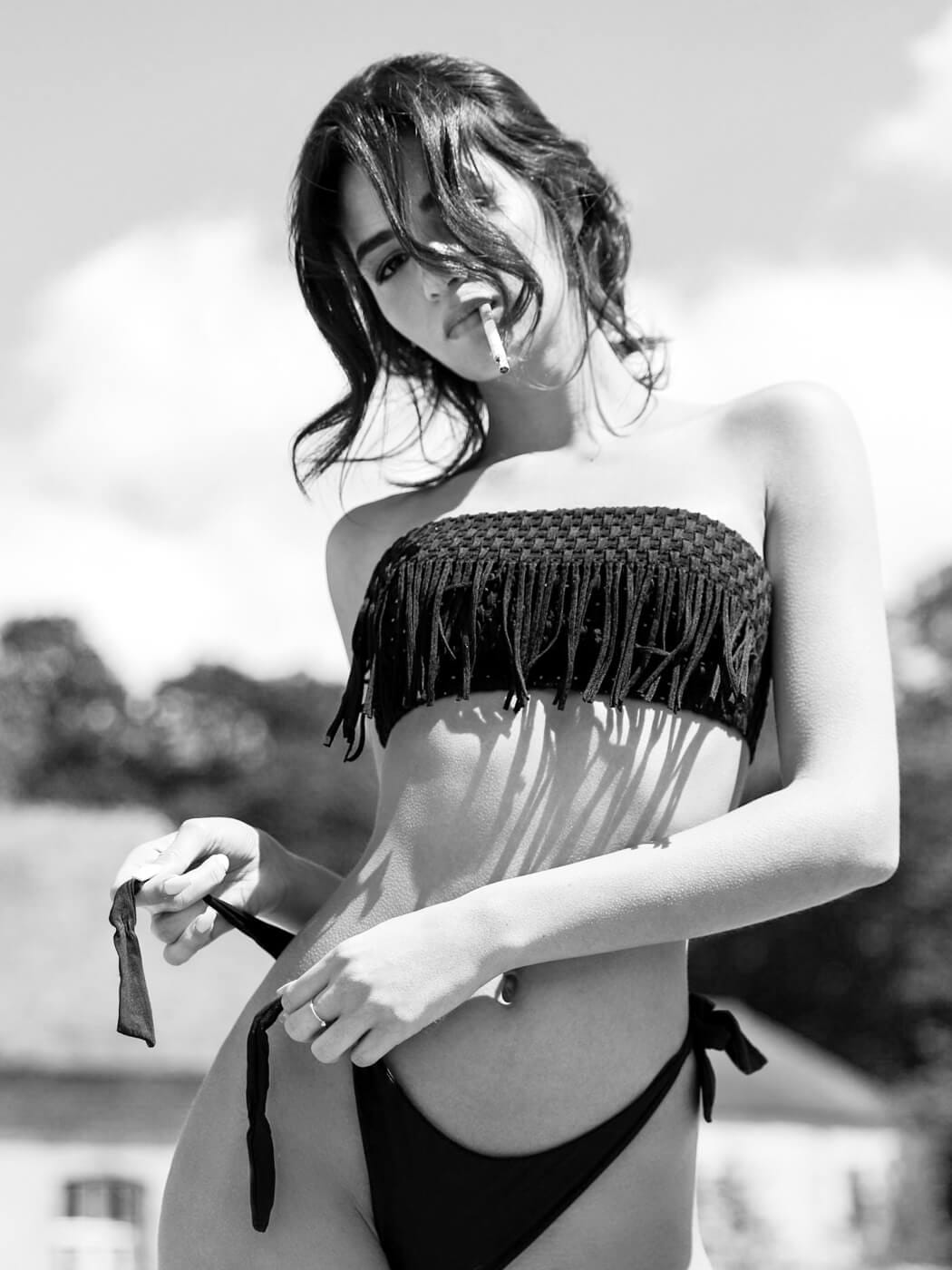 Provocative and sexy black and white boudoir photography in NYC, with a woman using a cigarette as prop.
