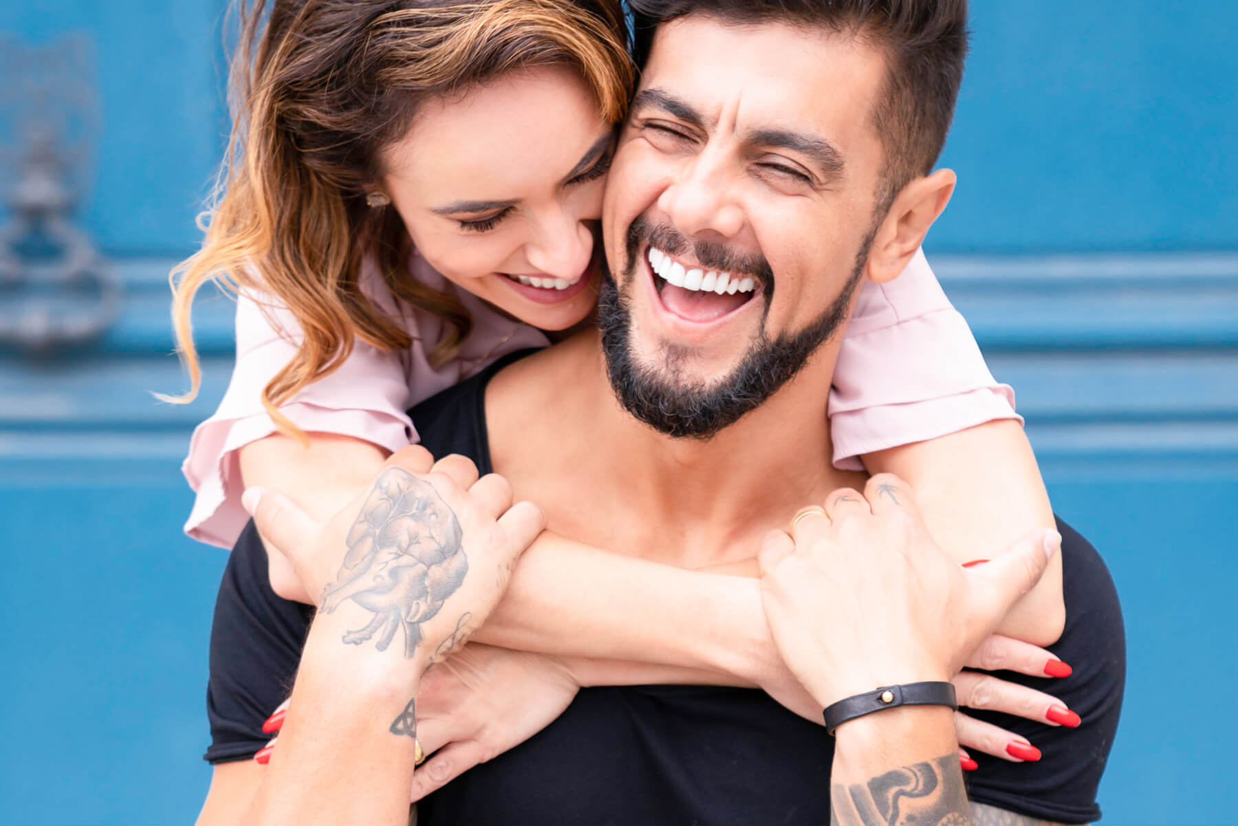 Happy Brazilian couple blissfully connecting amidst the vibrant energy of the Big Apple, New York City, in a candid moment during their NYC engagement session.