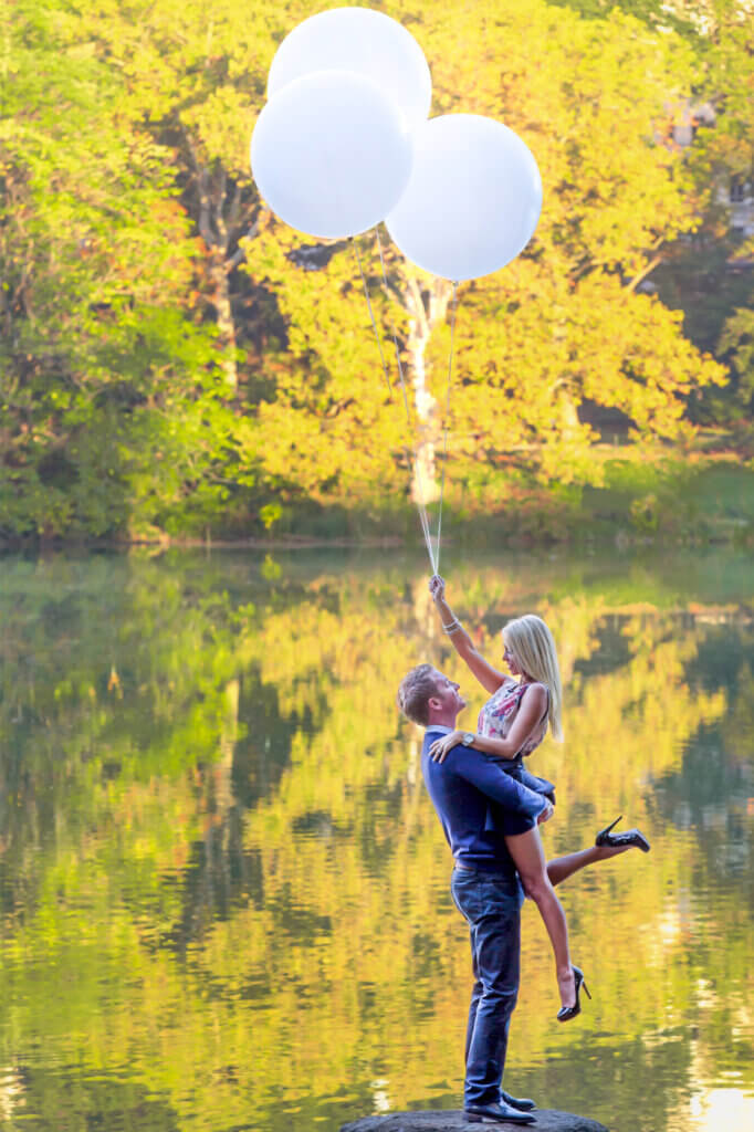 A stylish couple performs a beautiful lift in Central Park, near Bethesda Fountain, at sunrise to take advantage of the prettiest light.